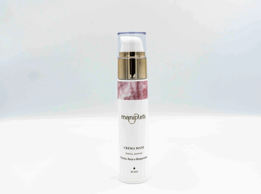 Flacone di crema mani Manipura fotografato dall’alto con tappo trasparente appoggiato accanto, su sfondo bianco.