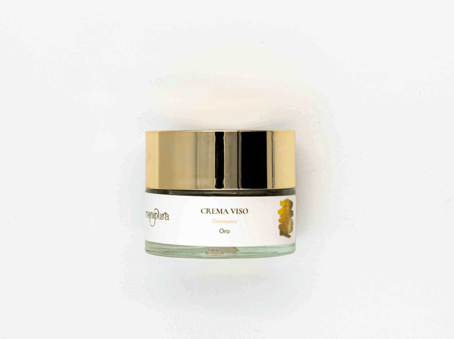 Vasetto di Crema Viso Illuminante Oro Manipura con tappo dorato, fotografato dall’alto su sfondo bianco.