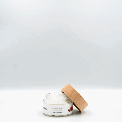 Vasetto della crema viso Rosa Damascena di Manipura con tappo in legno, appoggiato su sfondo bianco.